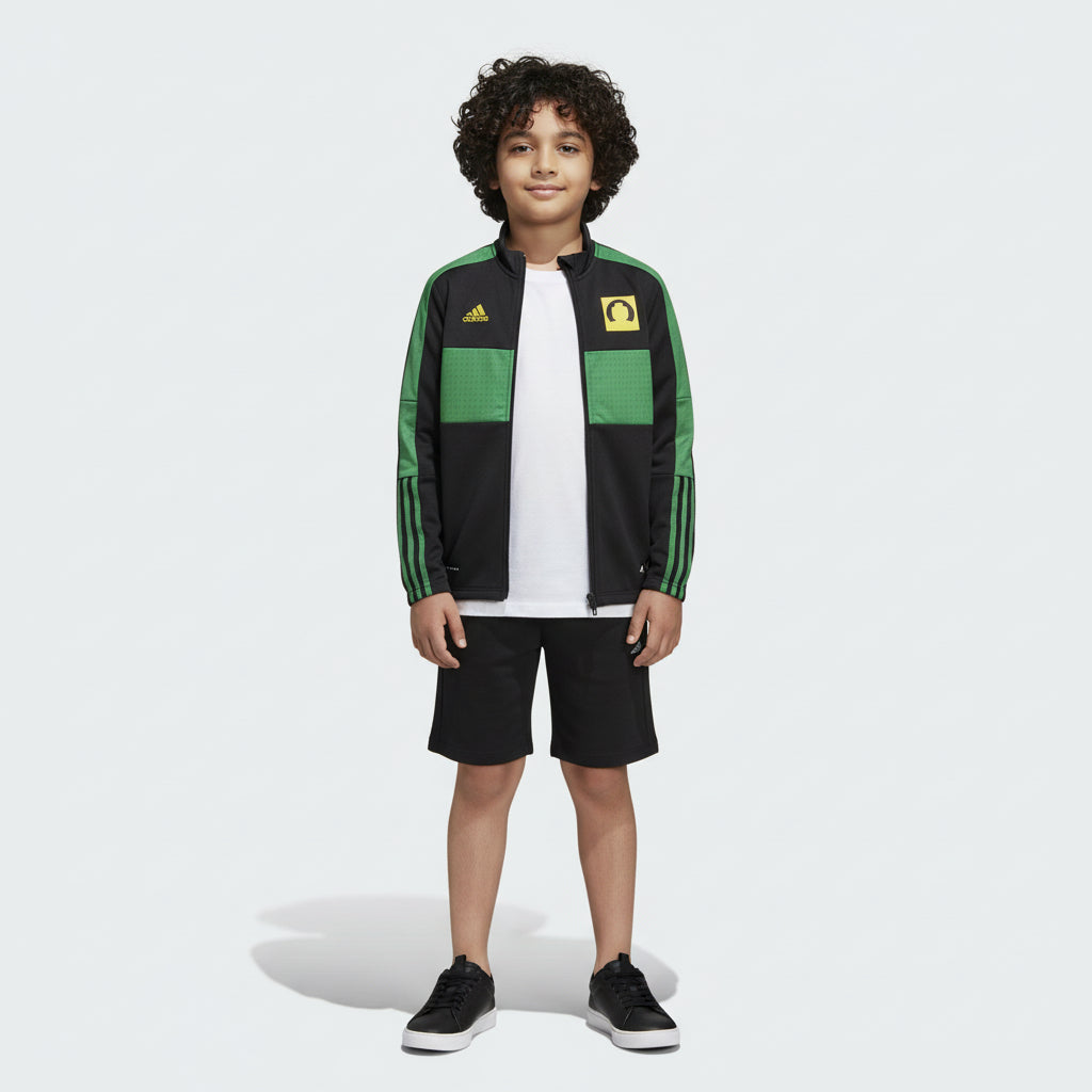 Child wearing a green and black Adidas tracksuit on a white background