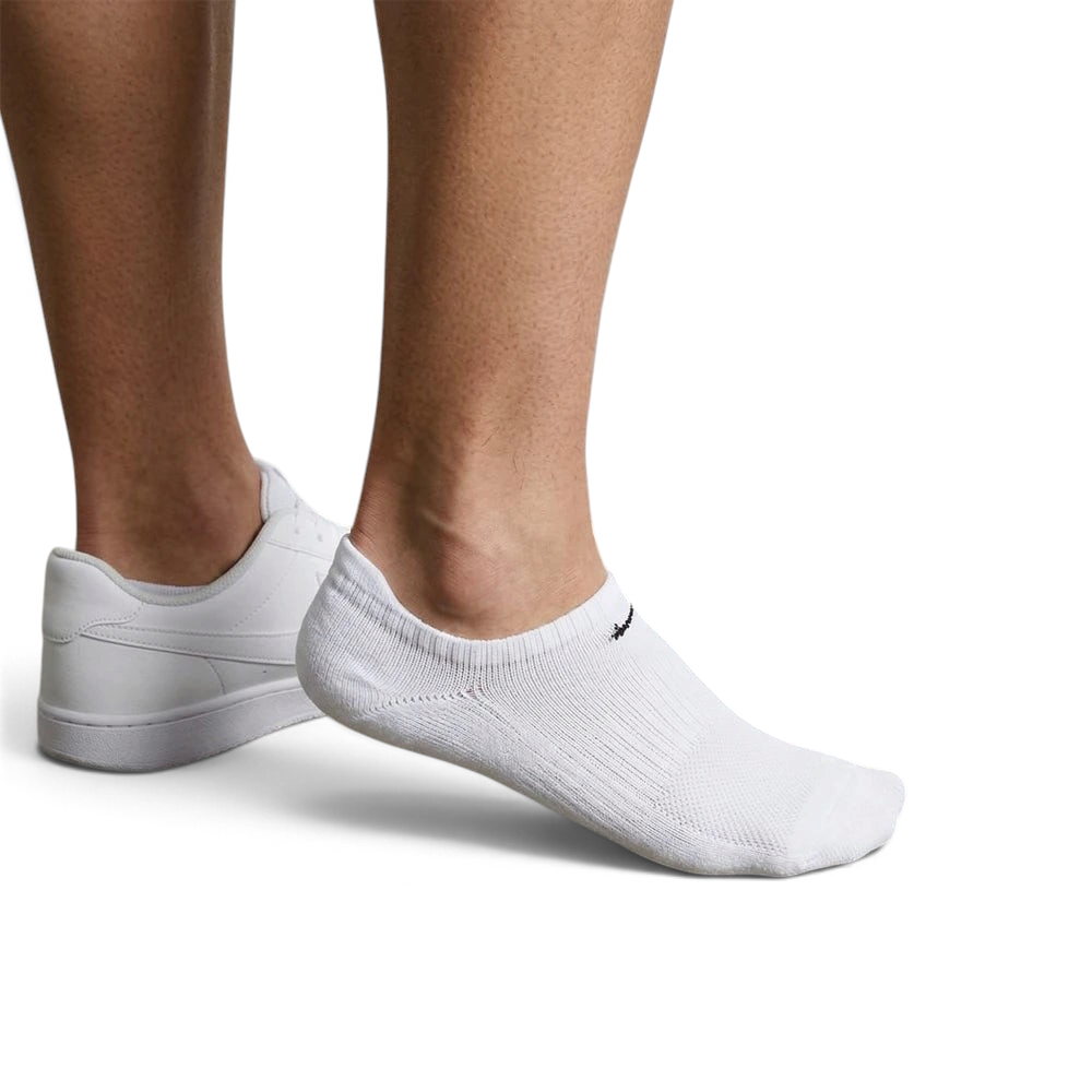 Trade Sports Nike white no-show socks worn with white sneakers, featuring a lightweight cotton-blend knit design.