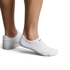 Trade Sports Nike white no-show socks worn with white sneakers, featuring a lightweight cotton-blend knit design.