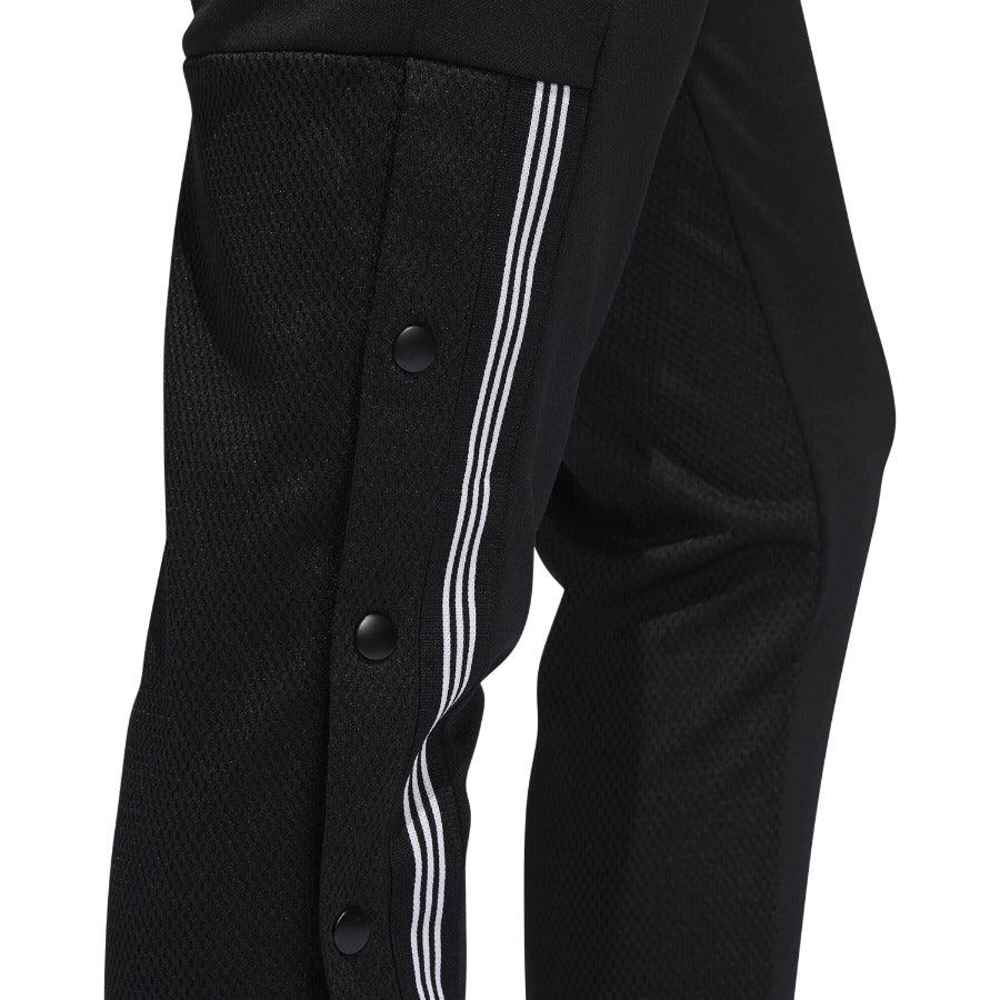 Close-up zoom on the Adidas 7/8 Cropped Snap Pants Women's in black, showing the individual snap buttons along the side and the texture of the knit fabric.