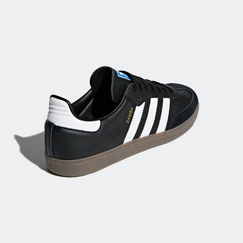 Rear view of the Adidas Samba OG Men's black trainers, focusing on the white heel tab with Adidas Trefoil logo and the gum sole.