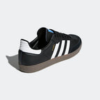 Rear view of the Adidas Samba OG Men's black trainers, focusing on the white heel tab with Adidas Trefoil logo and the gum sole.