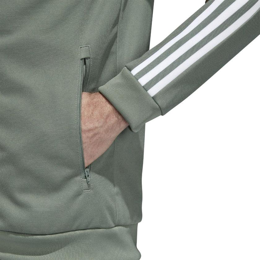 Adidas Beckenbauer Track Jacket Men's in trace green, side profile showing long sleeves with white 3-Stripes, ribbed cuffs, and regular fit.