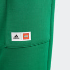 Close-up of adidas x LEGO Kids' Fleece Track Pants GN6803 elastic waist with LEGO logo