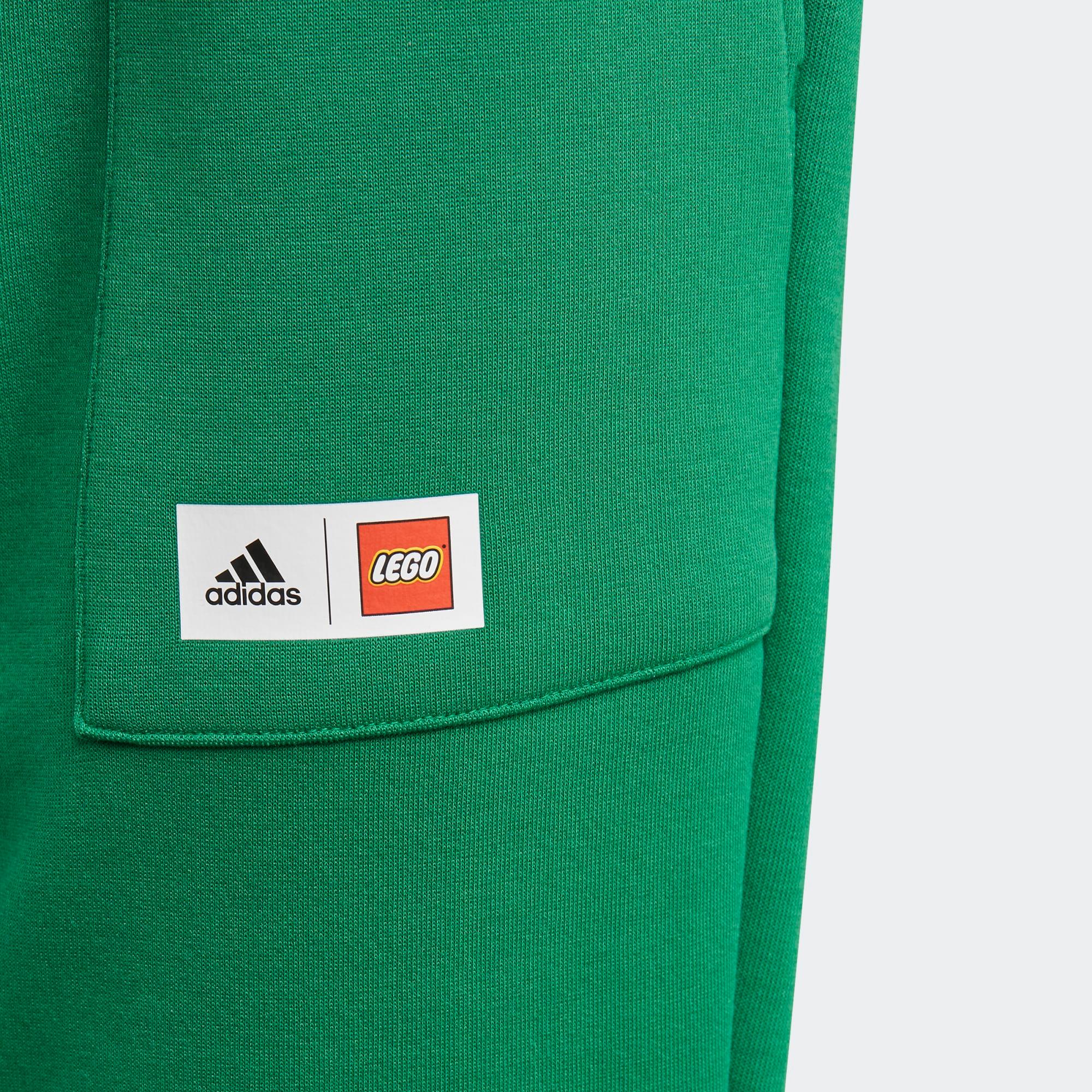 Close-up of adidas x LEGO Kids' Fleece Track Pants GN6803 elastic waist with LEGO logo