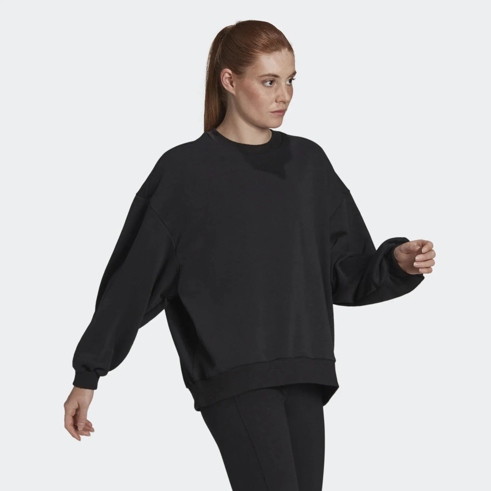 Highlights the loose, draped silhouette and the clean finish of the black French terry. Main image