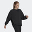 Highlights the loose, draped silhouette and the clean finish of the black French terry.