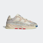 A pair of Adidas Niteball unisex sneakers with a leather upper, light misdle cushioning, and a rubber outsole, featuring a cream white color with grey, blue, and red accents.