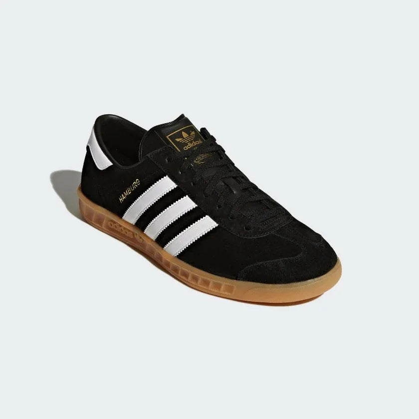 Angled view of adidas Hamburg Men's shoes highlighting premium suede texture and gold foil detail