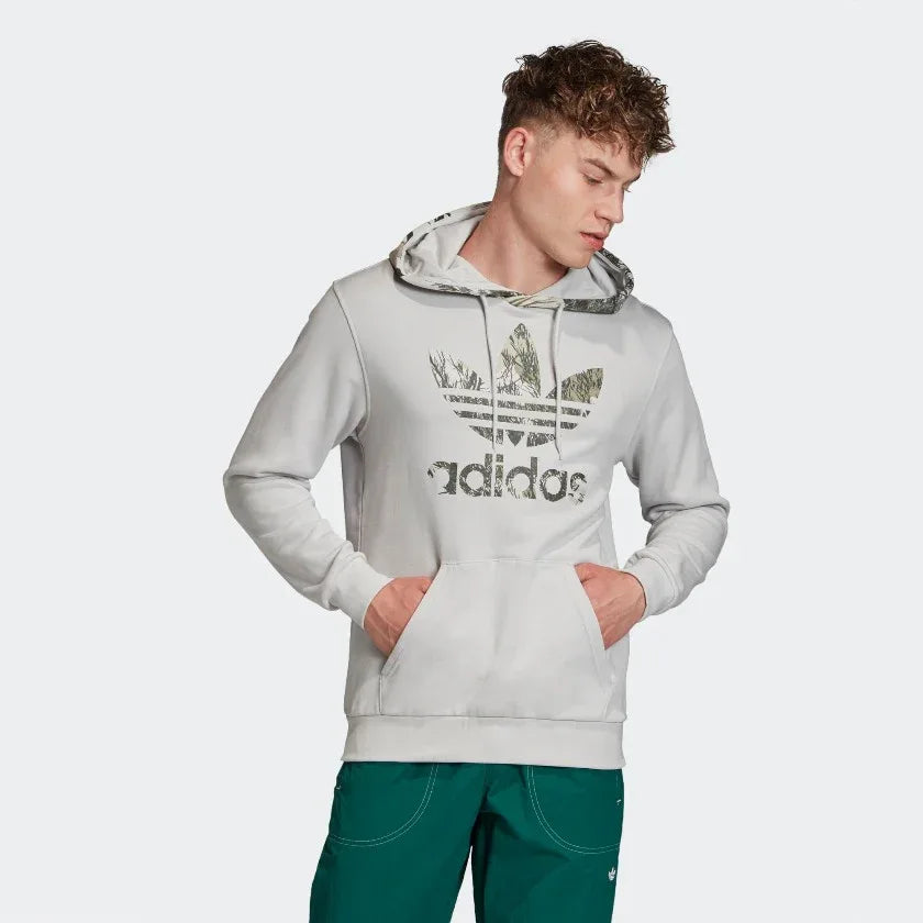 Adidas Originals Men's Camouflage Hoodie Sweater, front view showing the al-lover green camo print, kangaroo pocket, and a white Trefoil logo on the chest. Main image